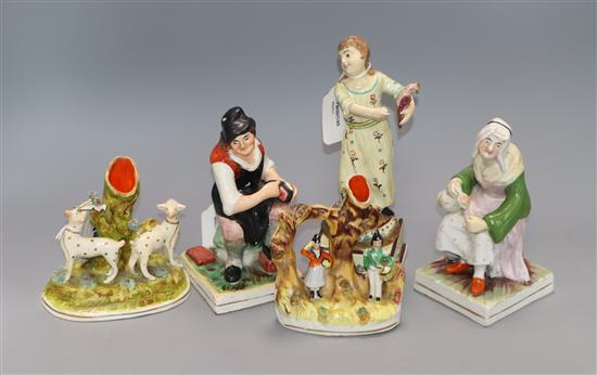 A pair of Staffordshire figures, cobbler and wife, a figure of a girl holding a bird and two spill vases,